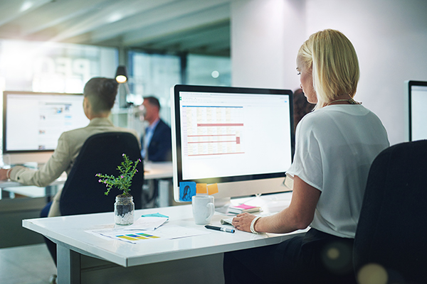woman at desk with screen